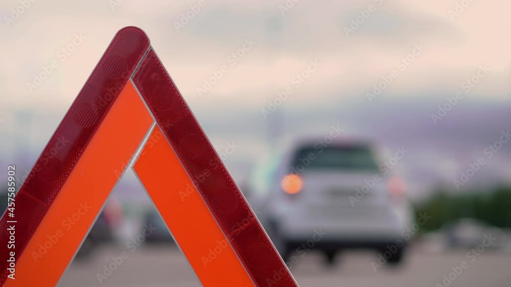 Warning triangle. A car with a flashing emergency light in the parking accident. Warning triangle. A car with a flashing emergency light in the parking accident.