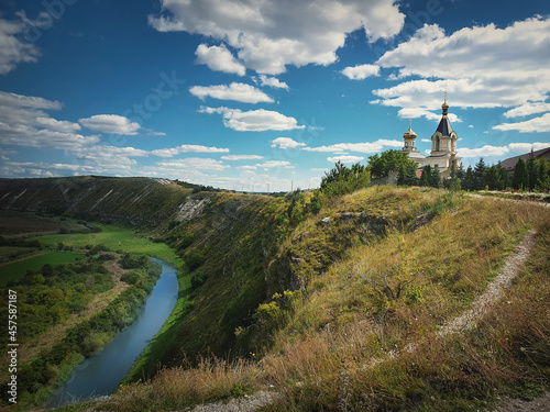 Scenic view from the hills to the Raut river at Orheiul Vechi (The old city of Orhei). Christian monastery on top of the cliff at Butuceni village, Moldova. photo