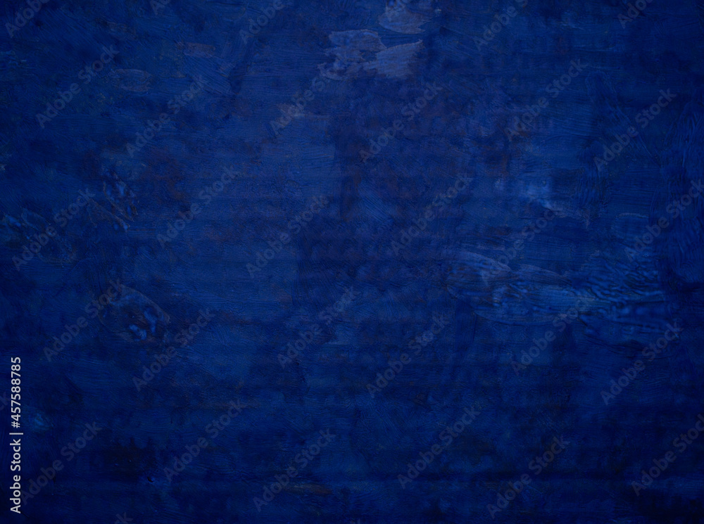 Background from the embossed surface of roughly painted blue paint with uneven saturation