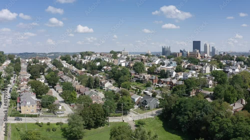 A rising summer aerial establishing shot of a Mount Washington neighborhood overlooking the city of Pittsburgh. A rising summer aerial establishing shot of a Mount Washington neighborhood overlooking the city of Pittsburgh.