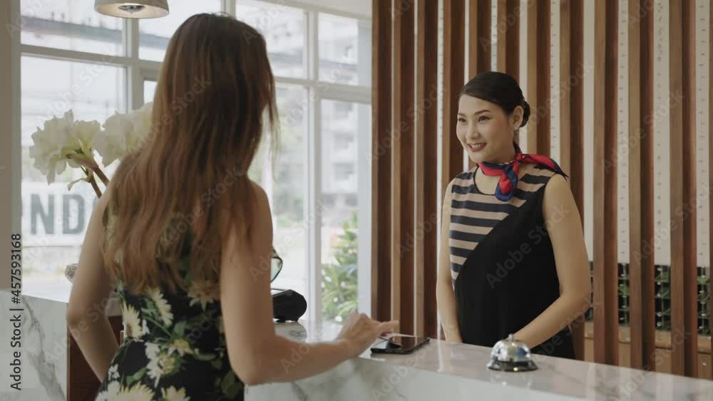 The guest is using a credit card with the edc machine to pay for services in the hotel lobby.
