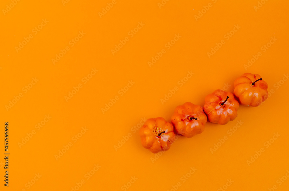 flatlay small orange pumpkins on orange background flatlay small orange pumpkins on orange background