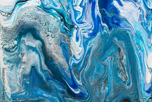 Texture in the style of fluid art. Abstract background with swirling paint effect. Liquid acrylic paint background. Blue, turquoise, white and gray colors.