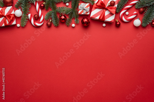 Red Christmas background with border decorated with holiday gifts photo