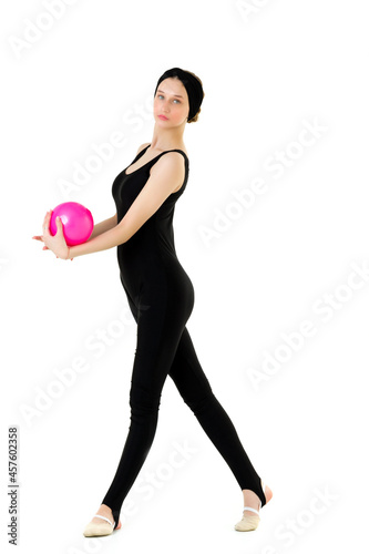 Young teen girl athlete exercising with pink ball