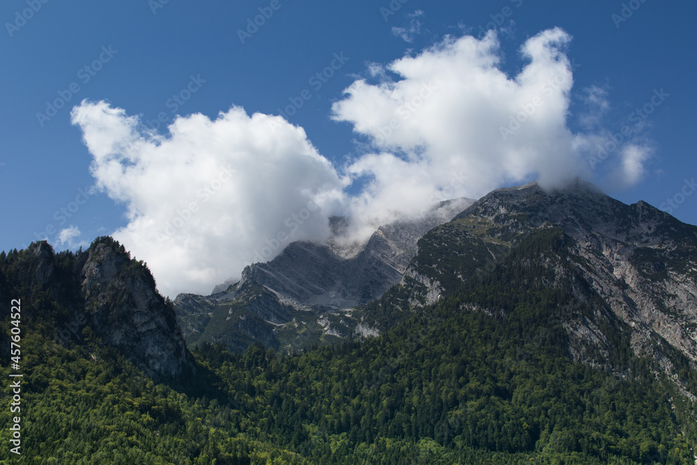 Shady rocky mountains in the Alps with cloudy sky, Austria Shady rocky mountains in the Alps with cloudy sky, Austria