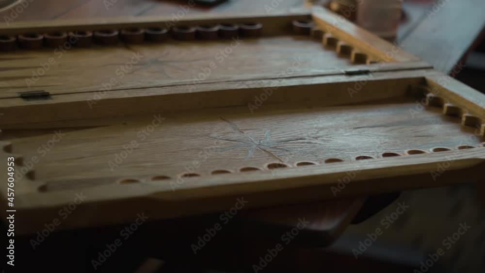 dice fall onto a wooden backgammon board and roll. the game starts. slow motion dice fall onto a wooden backgammon board and roll. the game starts. slow motion