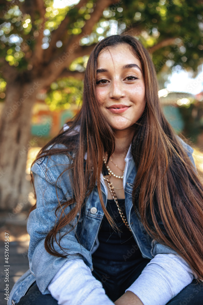 Cute teenage girl looking at the camera outdoors Cute teenage girl looking at the camera outdoors