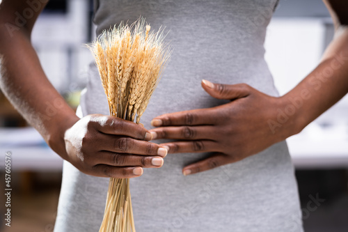 Celiac Disease And Gluten Intolerance. Women Holding Spikelet