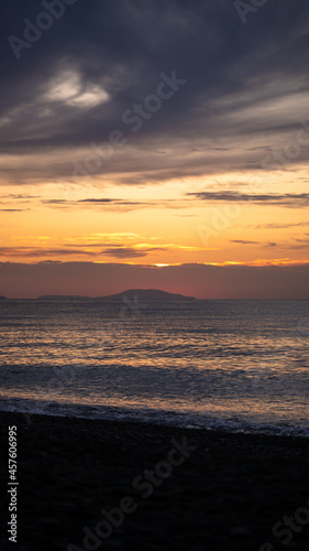 Amazing sunrise over the tropical beach. Yellow sun over sea. Orange colors waves. Nature background. Beautiful serene scene. Morning. Sunlight reflect on water surface