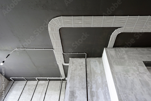 Electrical cables of wiring on house concrete ceiling. Renovation concept.