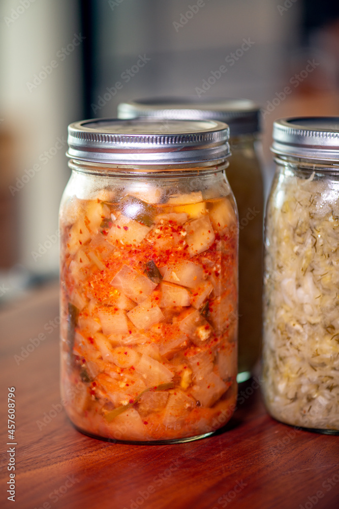 Delicious fermented kimchi and sauerkraut in mason jars Delicious fermented kimchi and sauerkraut in mason jars