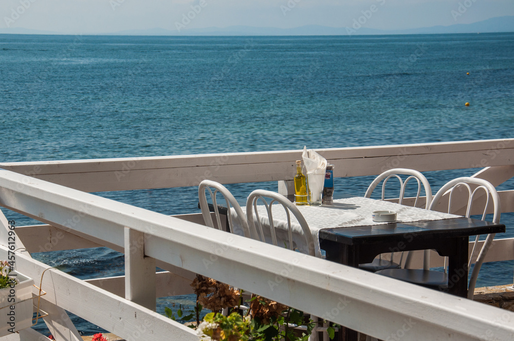 Fototapeta premium Wooden terrace in a restaurant with sea view