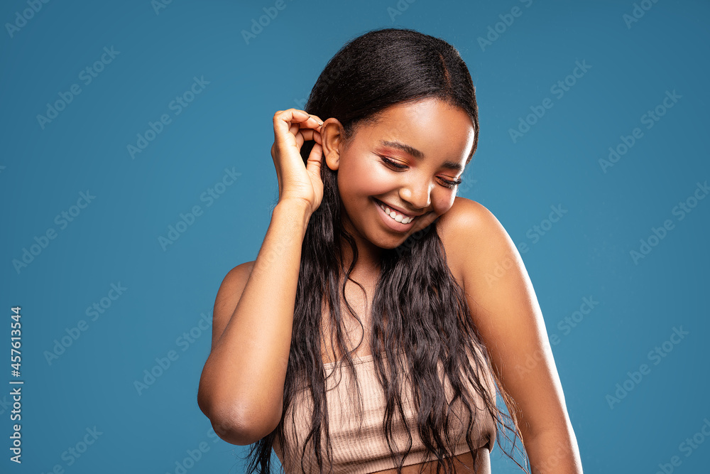 Fototapeta premium Photo of happy cute afro woman with beautiful smile and delicate glamour makeup,