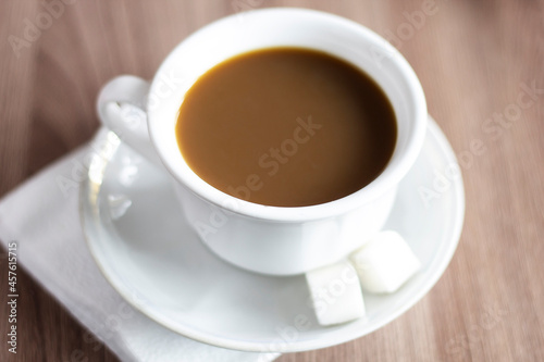 Closeup cup of coffee with sugar on plate beverage drinks cappuccino milk white caffeine