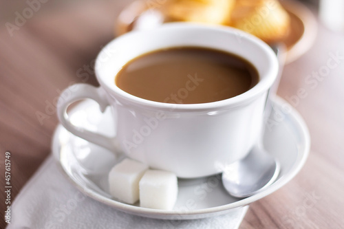 Closeup cup of coffee with milk and cakes on the table sweet morning breakfast espresso latte cappuccino mug drinks cafe stock