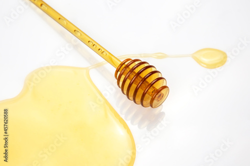 spoon with fresh honey spilled on a white background. organic vitamin food