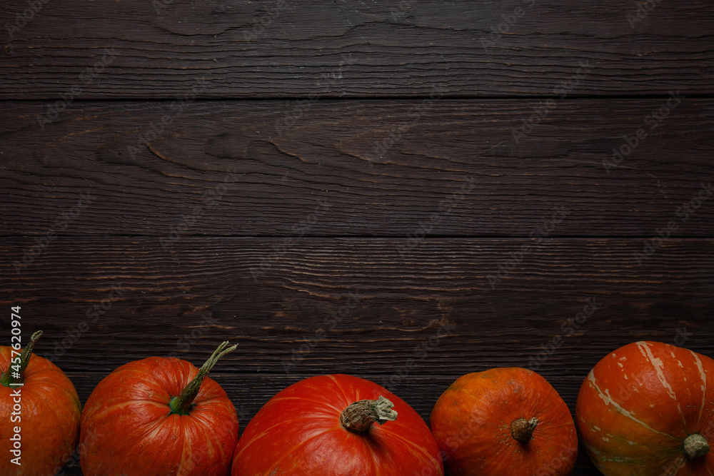 Pumpkins in a row on wooden table. Copy space. Pumpkins in a row on wooden table. Copy space.