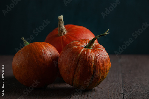 Pumpkins on wooden table in dark mood.