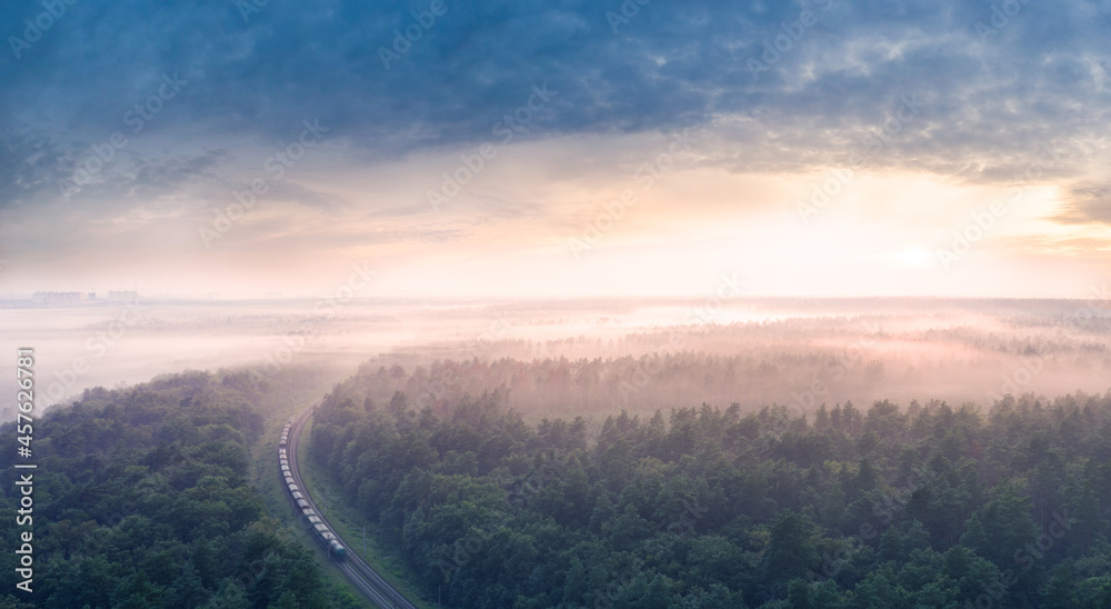 Dawn over the forest through which the railway line runs. Dawn over the forest through which the railway line runs.
