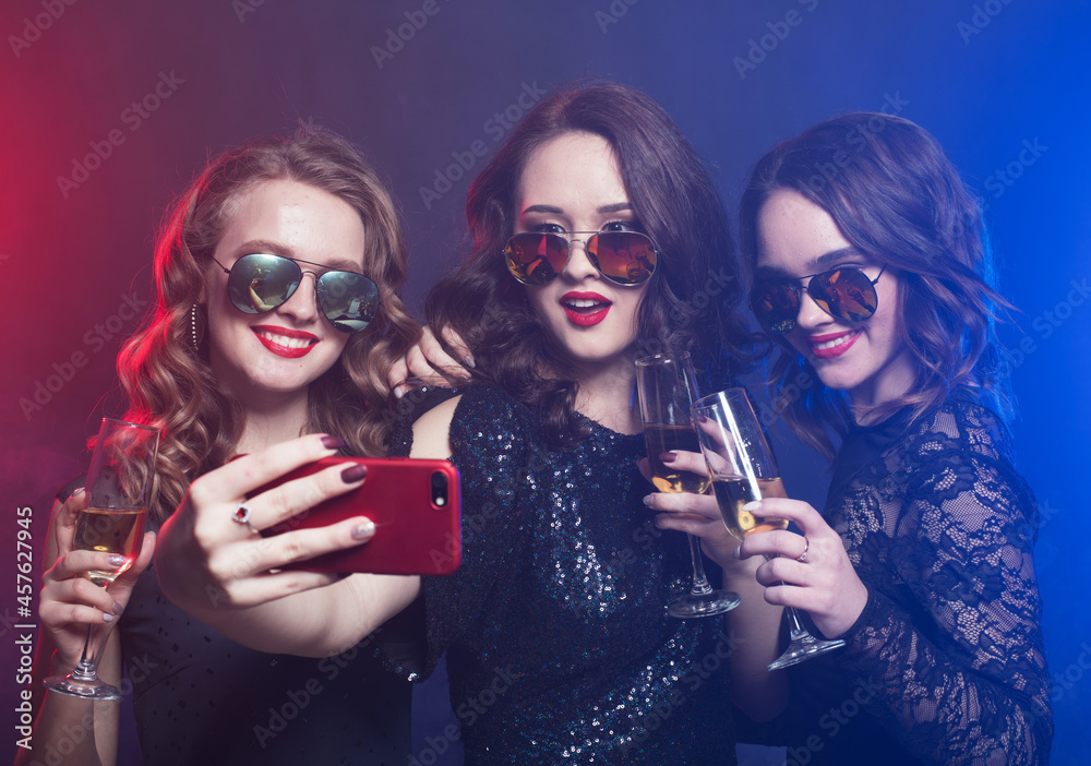Close-up shot of group of laughing girls having party, take selfie with smartphone