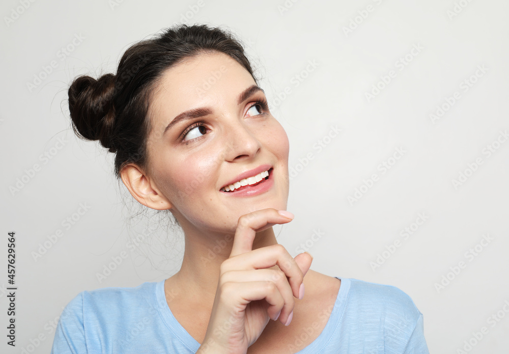 young woman dreamily looks up, ponders the future young woman dreamily looks up, ponders the future