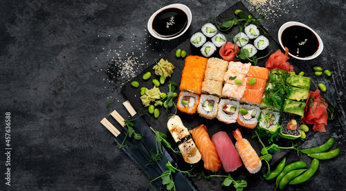 Photography Sushi and roll set on dark background. Traditional food concept.