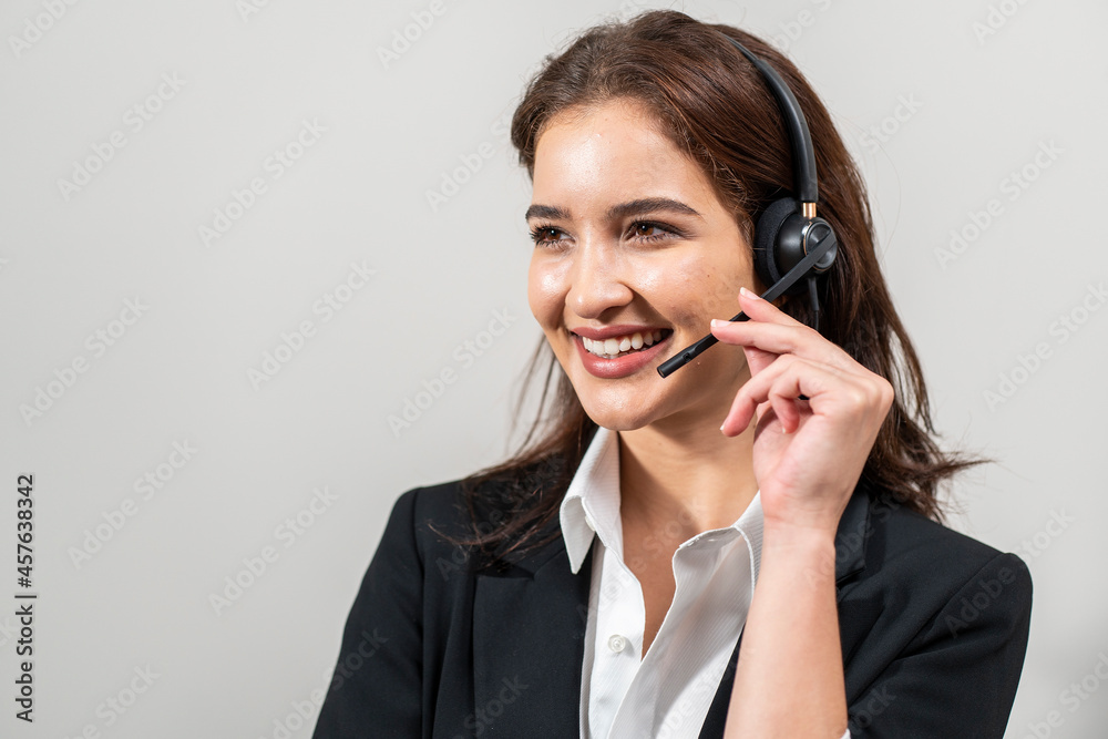 Beautiful girl wearing a headset talks to welcome customers calling for help or booking a room in a hotel. Beautiful girl wearing a headset talks to welcome customers calling for help or booking a room in a hotel.