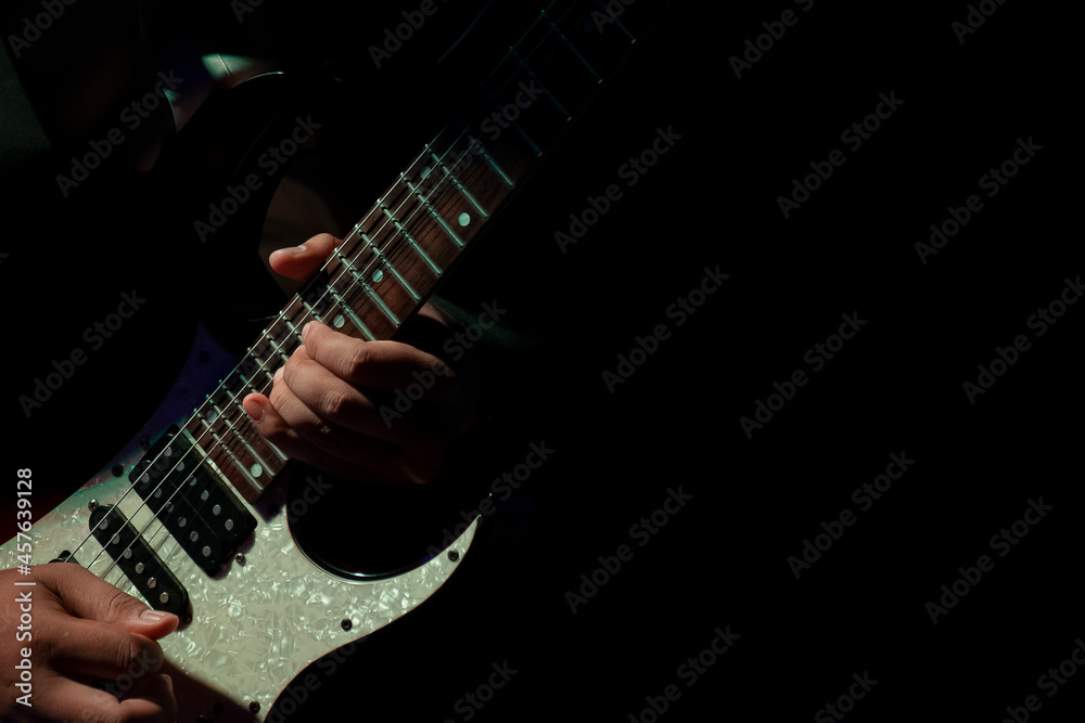 Abstact, Hand musician playing on guitar, Black background Abstact, Hand musician playing on guitar, Black background