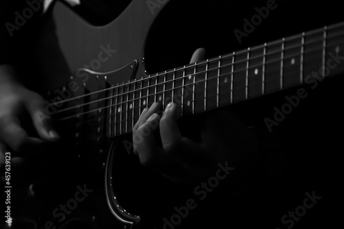 Abstact, blur musician playing on guitar, Black background