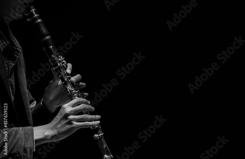 Abstact, Blur hand musician playing on clarinet, Black background