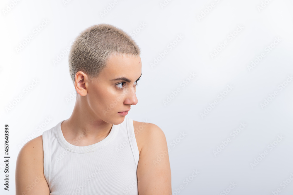 Young caucasian woman with short hair on a white background.