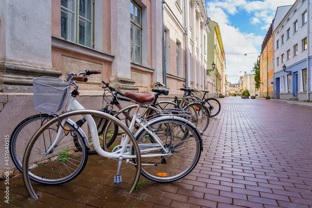 Bicycles parked on the cobbled street in the city of Tartu Estonia.