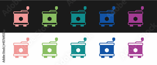 Set Honey extractor icon isolated on black and white background. Mechanical device for honey extraction from honeycombs. Vector