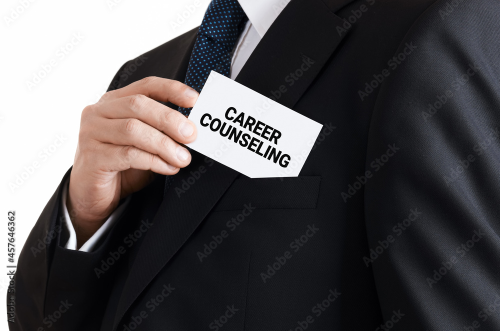 Businessman takes out a business card from his pocket with the message career counseling. Career development service Businessman takes out a business card from his pocket with the message career counseling. Career development service