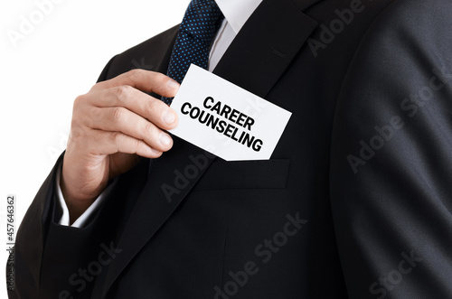 Businessman takes out a business card from his pocket with the message career counseling. Career development service