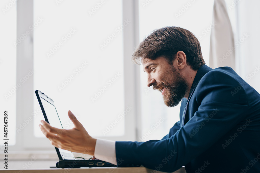 manager sitting at a desk in front of a laptop finance network technologies