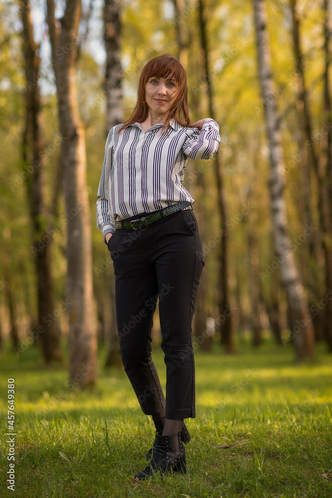 Portrait of a young beautiful girl posing in the park in full growth.
Portrait of a young beautiful girl posing in the park in full growth.