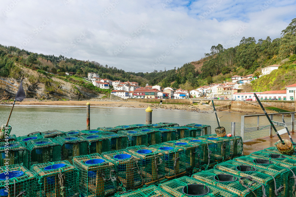 close up of fishing tackle in the port of tazones in asturias, spain. in the background you can see the white houses on a sunny day in the northern fishing port, the most beautiful village in spain.