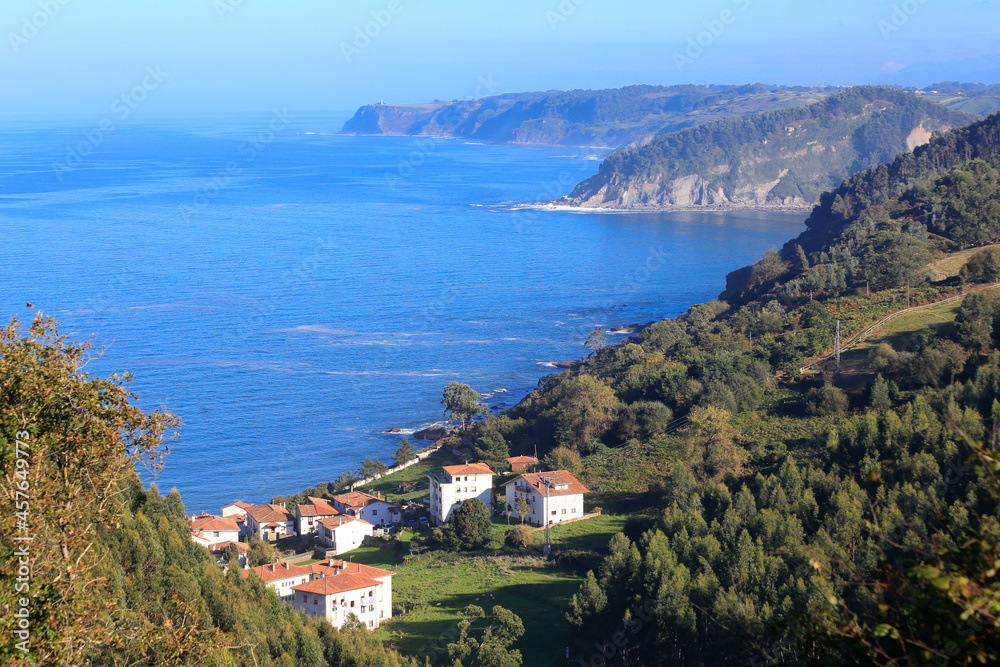 general view of the coast of villaviciosa with the entrance of the ria, rodiles and tazones in asturias, spain. view of the bay on a sunny day. northern fishing port, most beautiful village in spain.