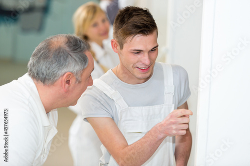 supervising a painter apprentice at work