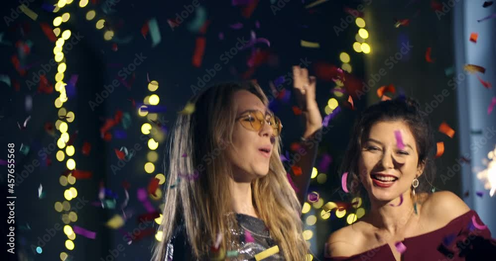 4k ProRes 422. Two young women celebrates dance the new year, Christmas, holiday, birthday. Blow up a and flies around confetti,friendship, corporate. 4k ProRes 422. Two young women celebrates dance the new year, Christmas, holiday, birthday. Blow up a and flies around confetti,friendship, corporate.