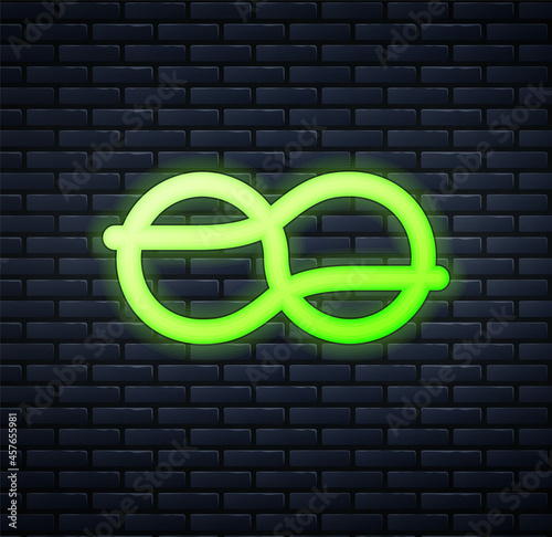 Glowing neon Nautical rope knots icon isolated on brick wall background. Rope tied in a knot. Vector