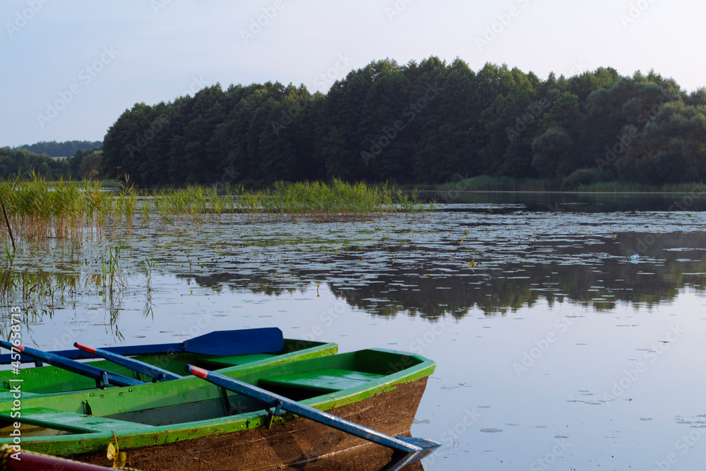 Obraz premium landscape with wooden boats on the river in Belarus