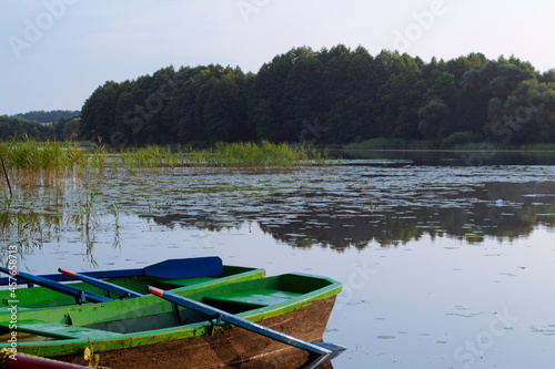 landscape with wooden boats on the river in Belarus