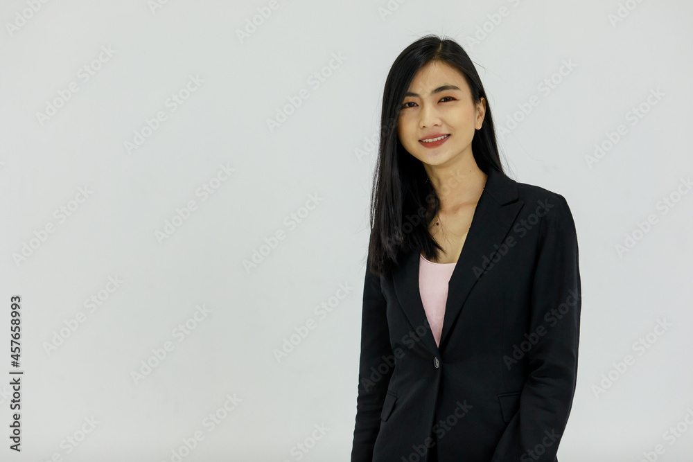 Isolated portrait studio shot of Asian young pretty smart confident happy professional success female businesswoman officer in black formal suit standing smiling look at camera on white background Isolated portrait studio shot of Asian young pretty smart confident happy professional success female businesswoman officer in black formal suit standing smiling look at camera on white background