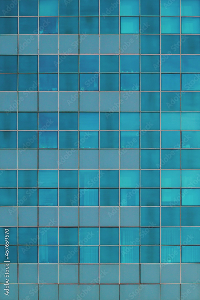Blue glass wall of skyscraper. Office building windows.