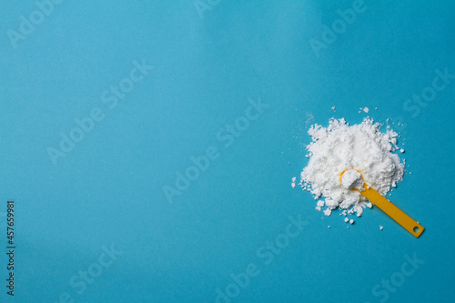sports supplement creatine powder on pale blue background copy space photo