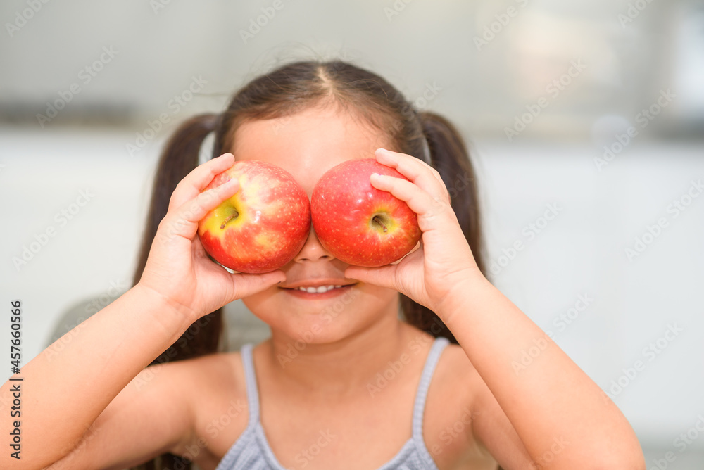 Healthy food for children. Funny image of little girl showing two apples. Healthy food for children. Funny image of little girl showing two apples.
