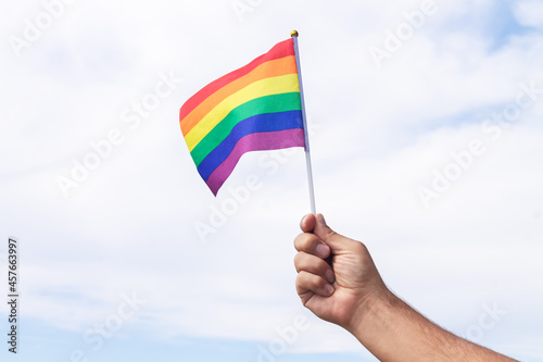 Holding gay pride symbol rainbow flag